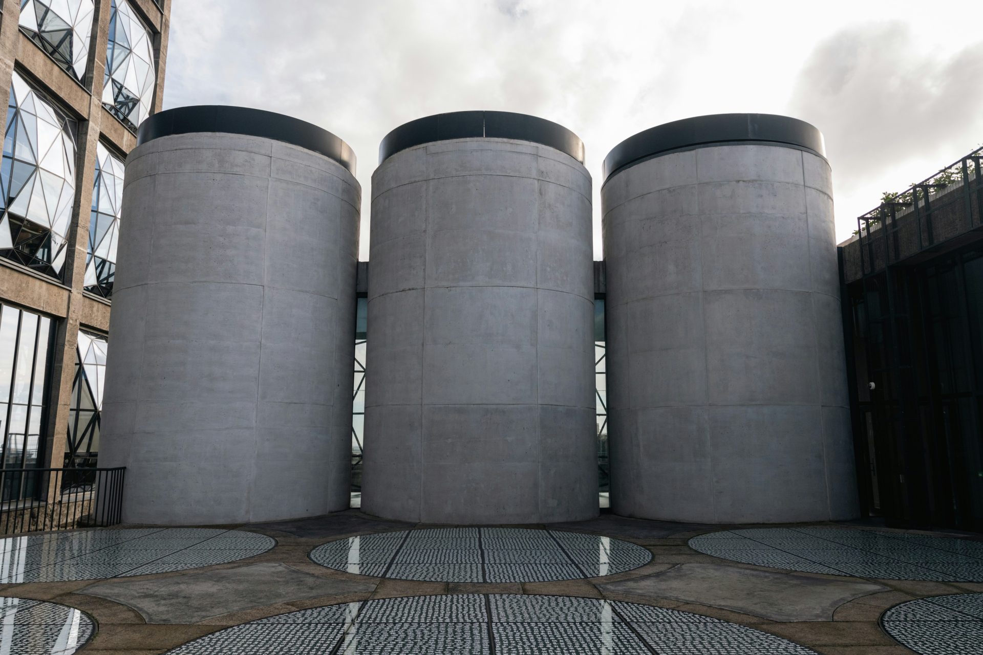 Three large concrete cylinders on a rooftop